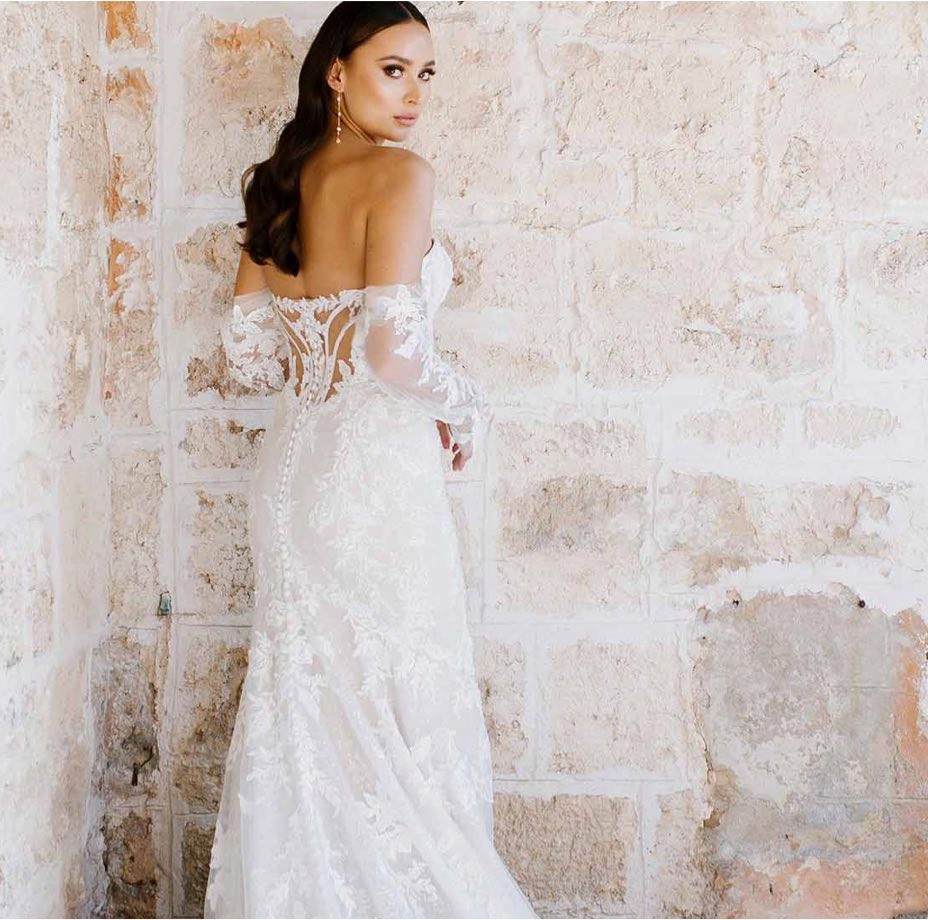 Model wearing a white gown by Martina liana