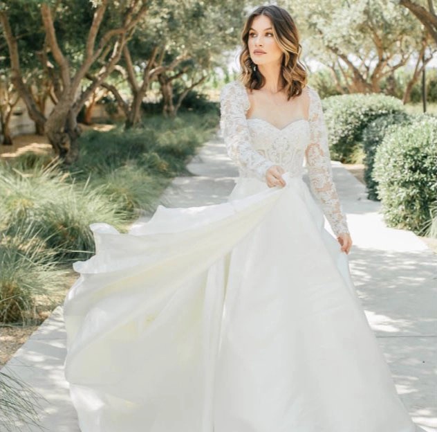 Model wearing a white gown by Martina liana