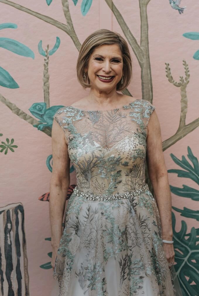 Mother of bride wearing a cream and green colored evening dress