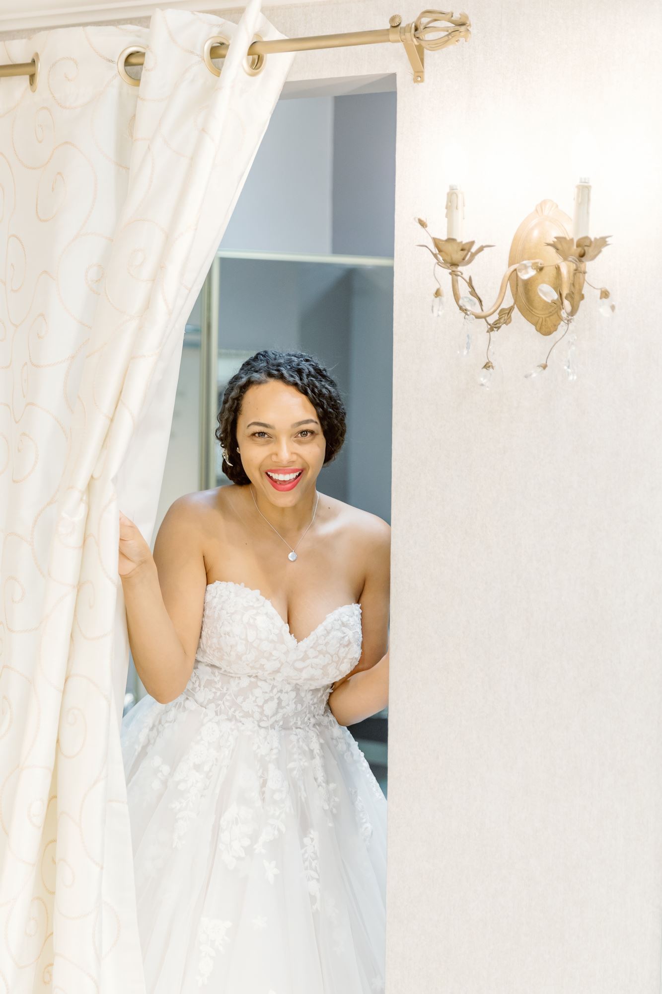 Bride wearing white strapless wedding dress at Lili Bridals.