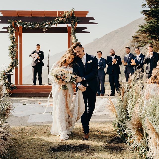 Bride Wearing Boho Wedding Dress Walking Down The Aisle With Groom