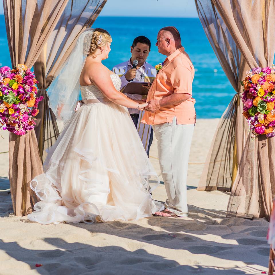 Plus Size Bride Wearing A White Strapless Dress At A Beach Ceremony.