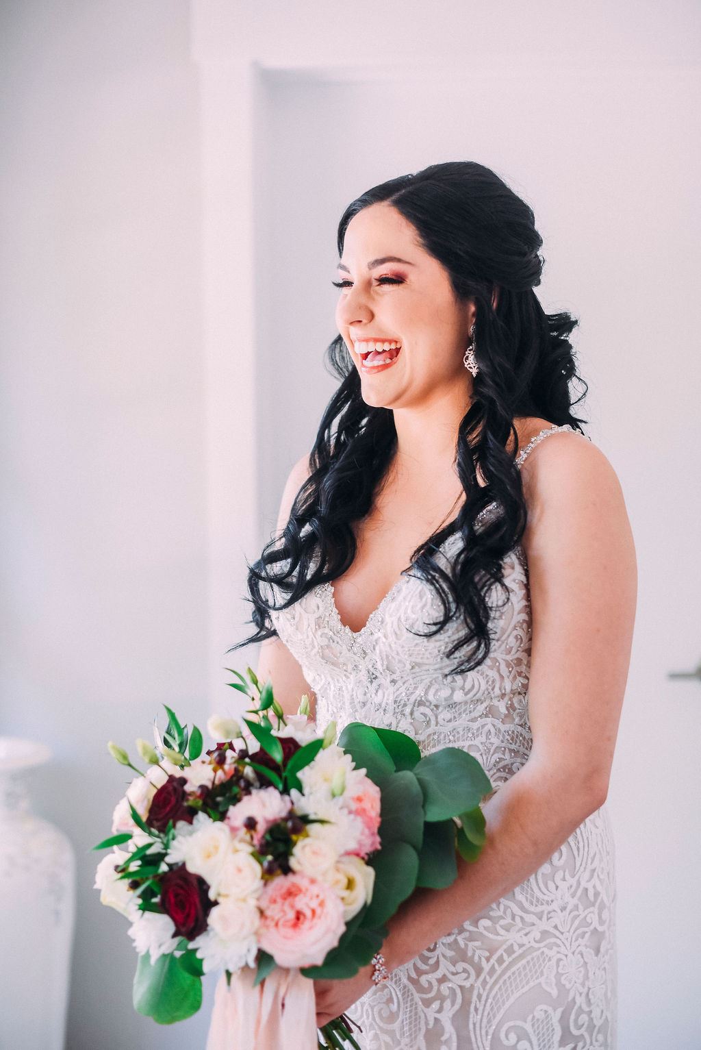 Bride Wearing White Wedding Dress Holding Bouquet With White And Pink Flowers